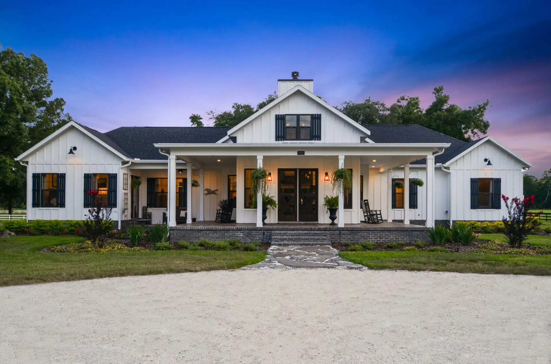 Warm exterior lighting on a completed McGinnis Builders custom home