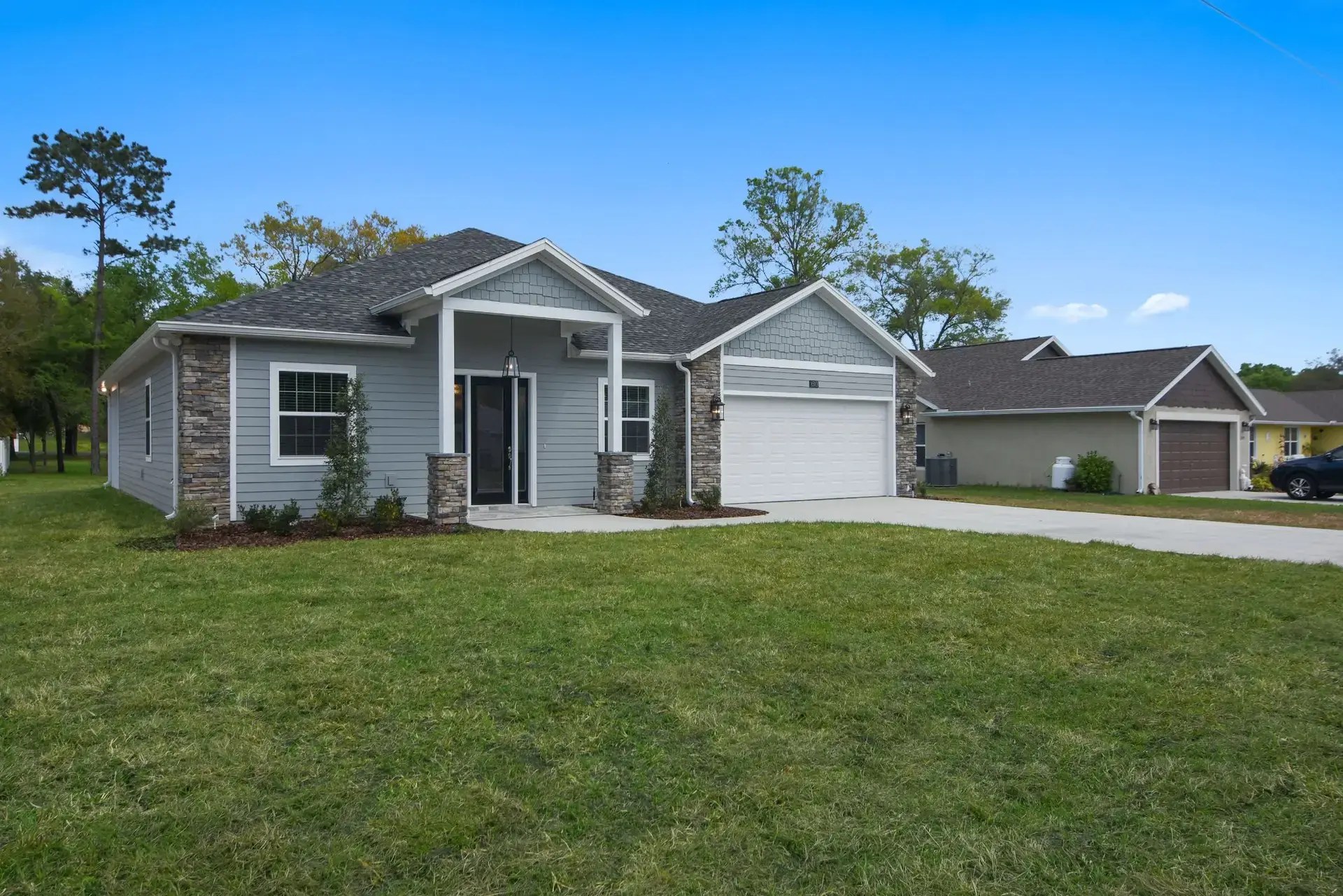 Angled view of a completed gray custom home