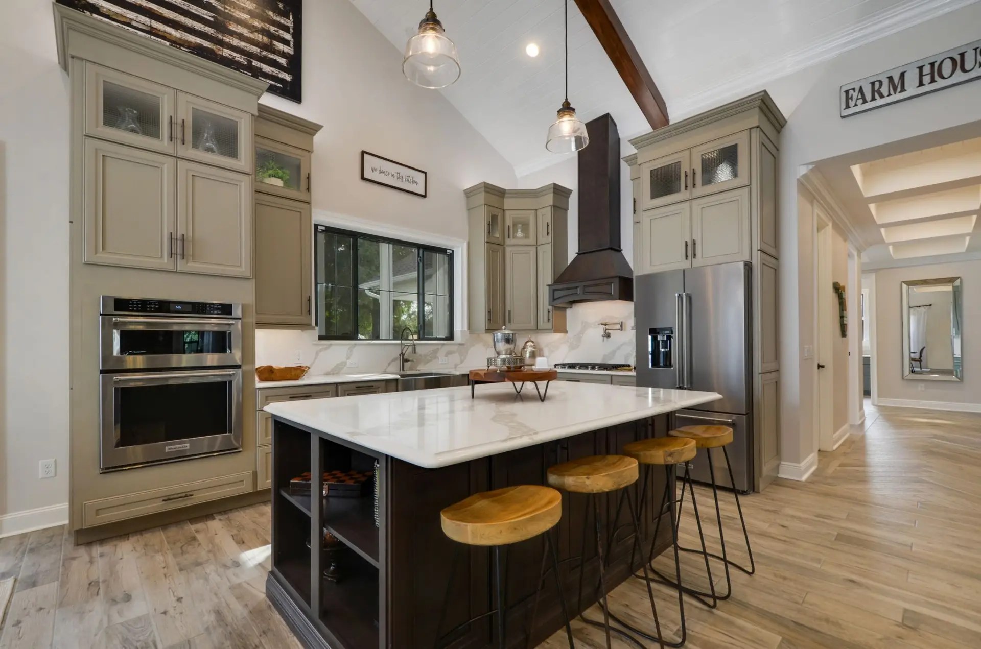 Finished custom home kitchen with island and gathering space