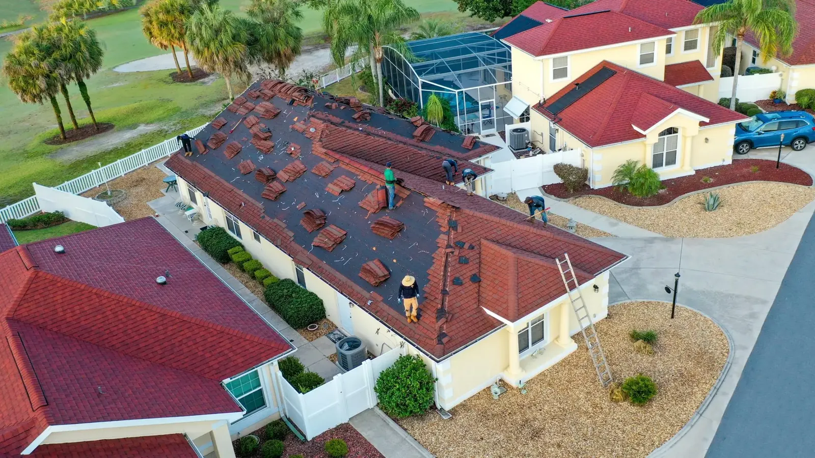 Aerial view of a roofing crew removing the old roof on a home in The Villages, FL